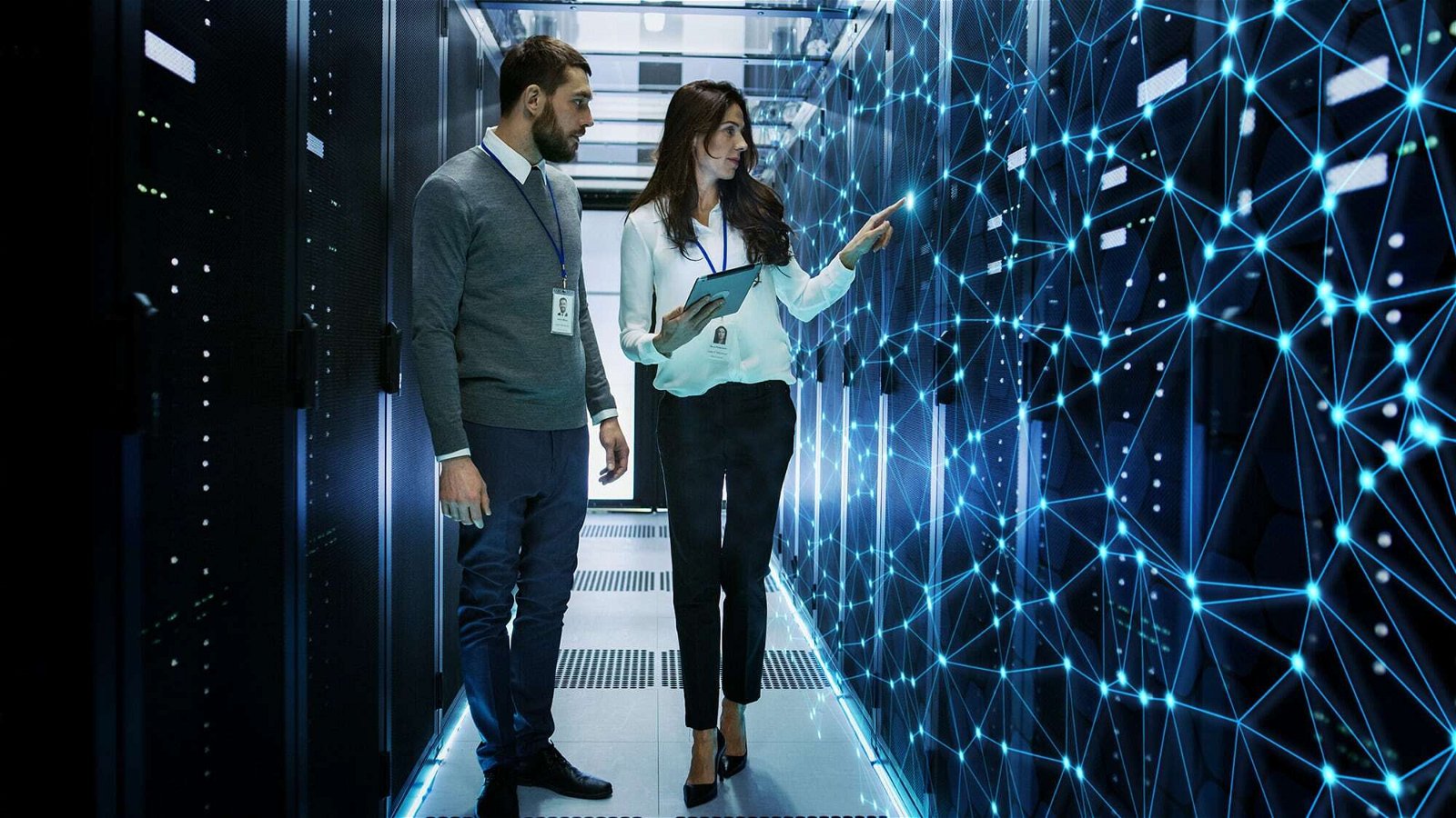 a man and a woman standing in a server room.